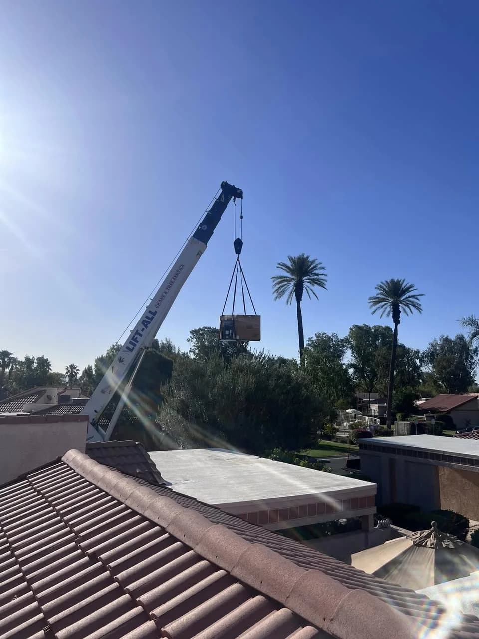 HVAC unit being lifted by crane